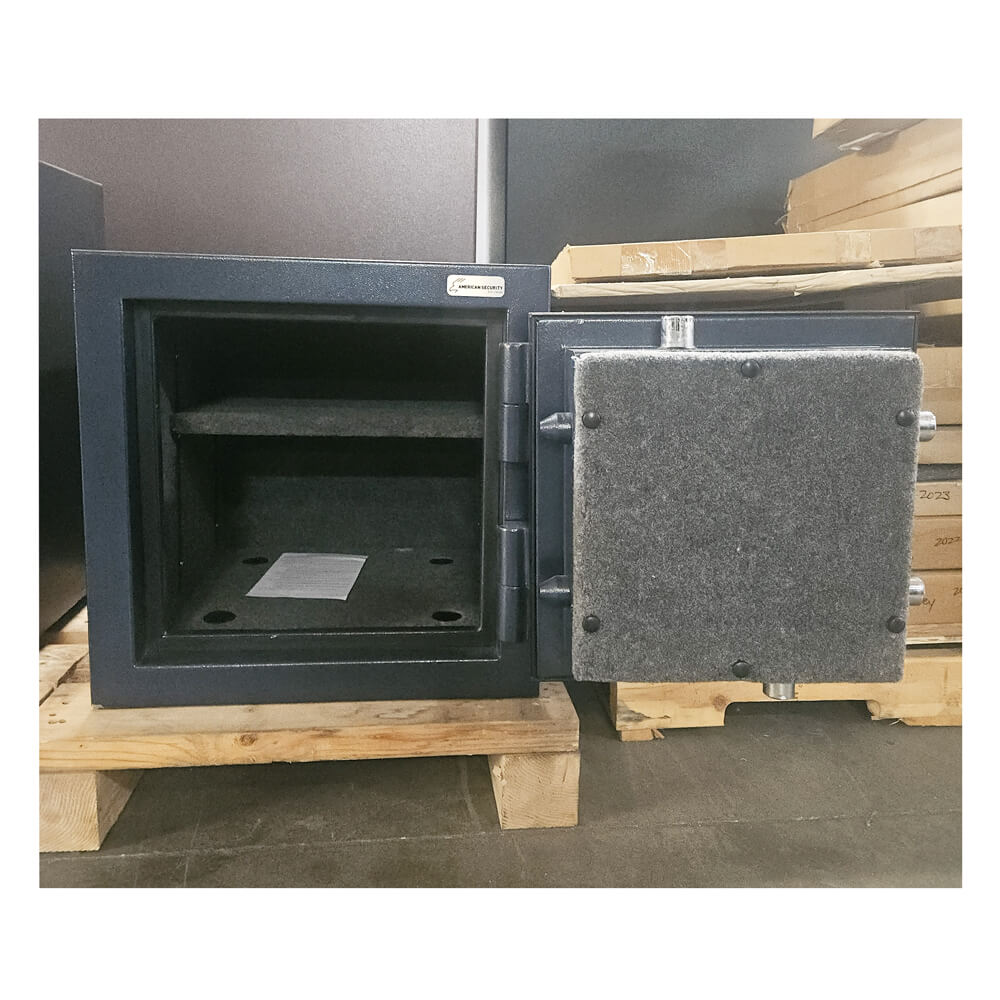 Black safe on a wooden pallet with a gray background