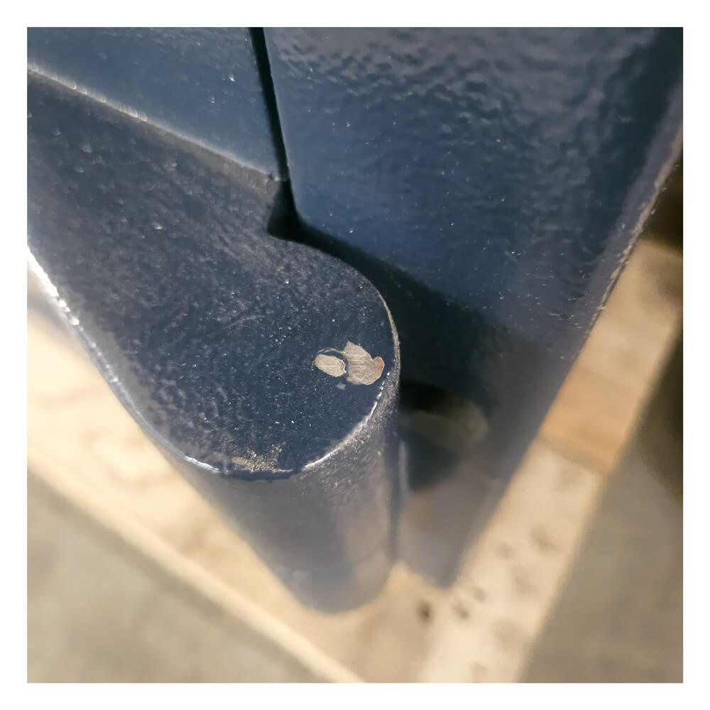 Close up of a door hinge on a blue safe