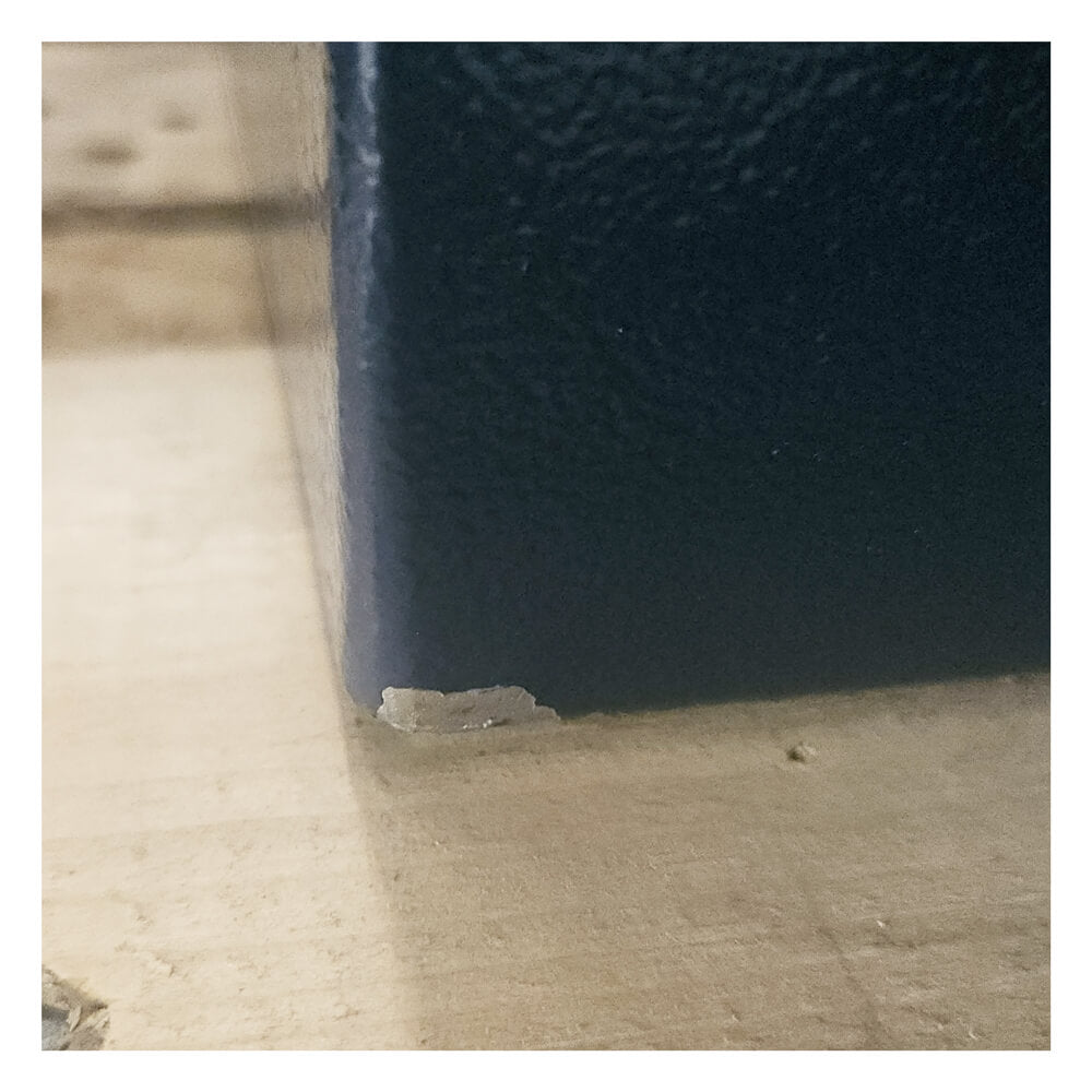 Close-up of a dark blue safe on a light-colored surface